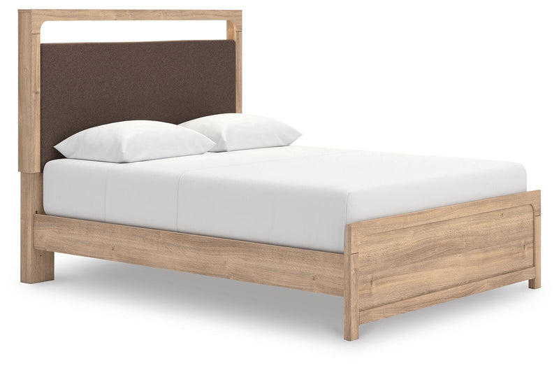 Ashley Furniture Kinlanni bedroom set with a bed, matching nightstands, and dresser in a cozy bedroom setting.