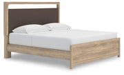 Ashley Furniture Kinlanni bedroom set with a bed, nightstands, and a dresser, shown in an angled view in a modern bedroom setting