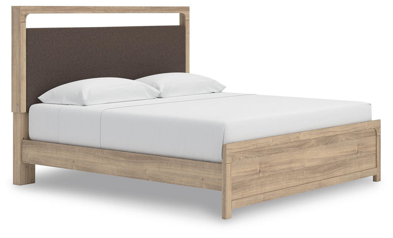 Ashley Furniture Kinlanni bedroom set with a bed, nightstands, and a dresser, shown in an angled view in a modern bedroom setting