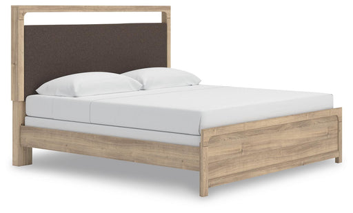 Ashley Furniture Kinlanni upholstered bed with a padded headboard and neutral fabric, shown from an angled side view.