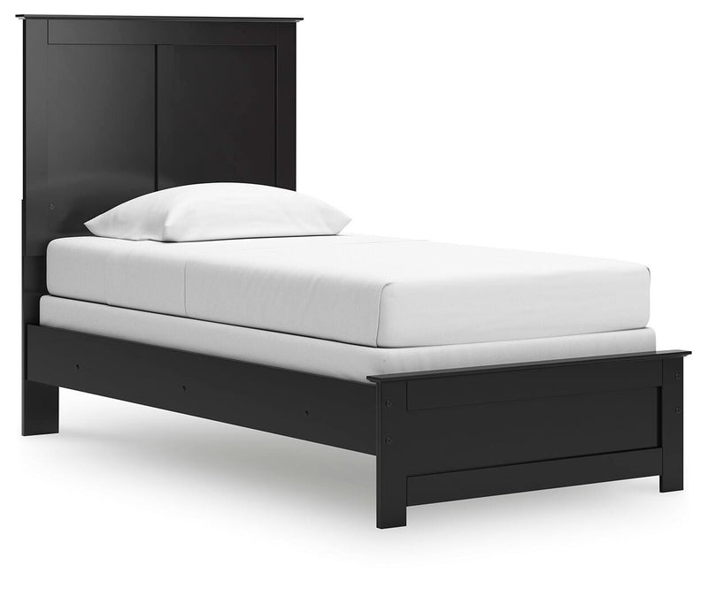 Ashley Furniture Maribel Bed with elegant wooden frame and upholstered headboard, shown from a side angle.