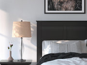 Close-up of the Ashley Furniture Maribel Bed showing detailed wood finish and elegant headboard design.