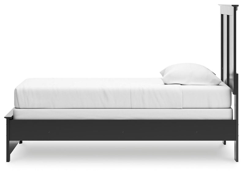 Ashley Furniture Maribel Bed with a stylish upholstered headboard and classic wooden frame, shown from a side angle.