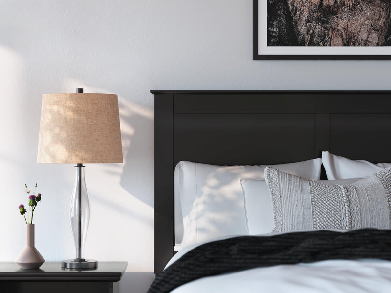 Close-up of Ashley Furniture Maribel Bed with detailed wooden headboard and rich dark finish.