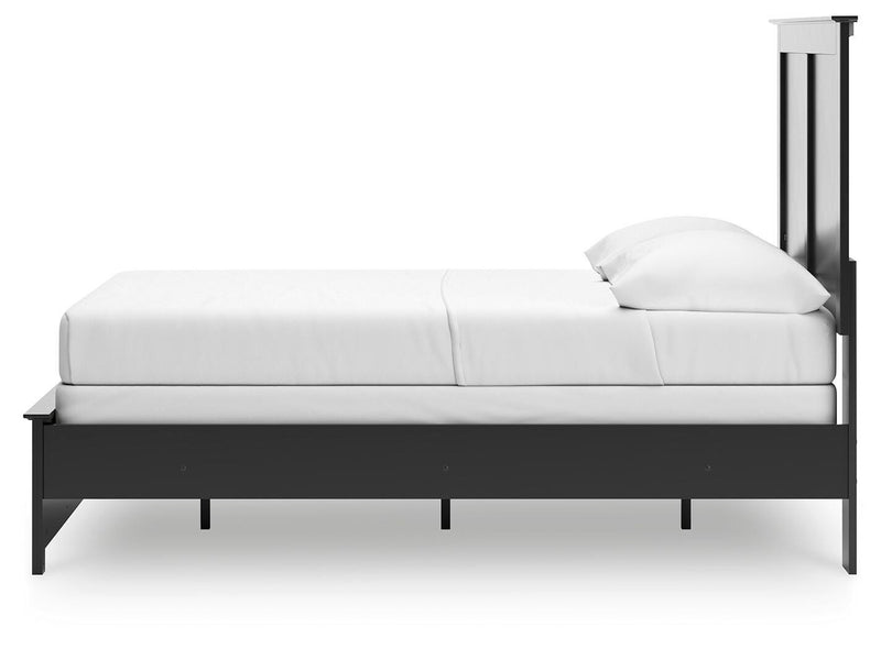 Ashley Furniture Maribel Bed in a cozy bedroom setting with a stylish upholstered headboard and elegant wooden frame.