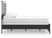 Ashley Furniture Maribel Bed with a sleek, modern design shown from the side in a stylish bedroom setting.
