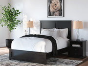 Ashley Furniture Maribel Bed with upholstered headboard and wood frame, shown in a stylish bedroom setting.