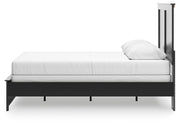 Ashley Furniture Maribel Bed with a sleek wood finish and modern design, shown in a cozy bedroom setting.