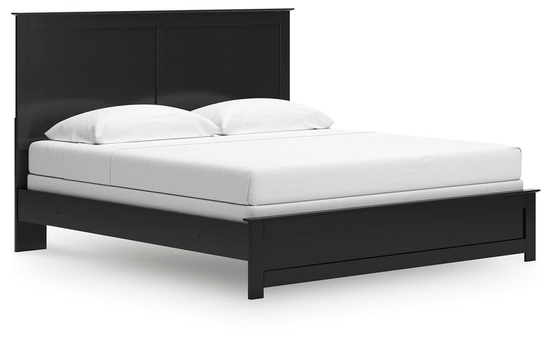 Ashley Furniture Maribel Bed with elegant upholstered headboard and wooden frame, shown from an angled side view.