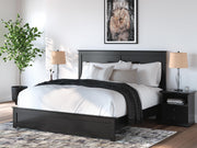 Ashley Furniture Maribel Bed with upholstered headboard and wooden frame, shown in a stylish bedroom setting.