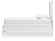 Ashley Furniture Bostwick Shoals bed with a classic wooden frame and neutral finish, shown from a side angle.