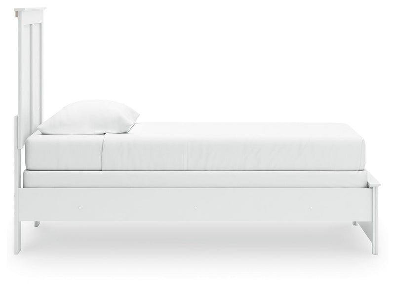 Ashley Furniture Bostwick Shoals Bed with a wooden frame and headboard, shown from a side angle in a well-lit bedroom setting.