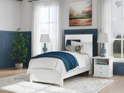 Ashley Furniture Bostwick Shoals Bed with wooden frame and upholstered headboard in a modern bedroom setting.