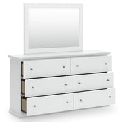 Ashley Furniture Bostwick Shoals dresser and mirror set with open drawer and mirror reflecting bedroom scene.
