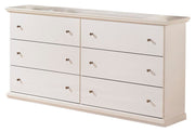 Ashley Furniture Bostwick Shoals Youth Dresser with multiple drawers and a dark wood finish, shown in a well-lit room setting.