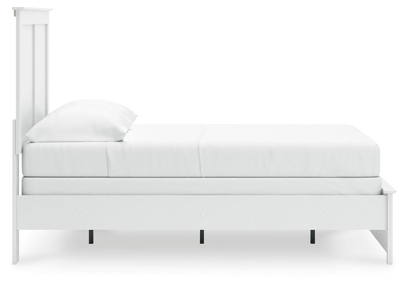 Ashley Furniture Bostwick Shoals bedroom set with a bed, nightstands, and dresser in a classic wood finish, shown in a modern bedroom.