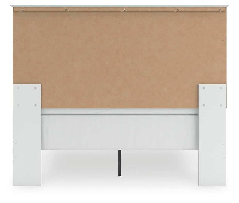 Ashley Furniture Bostwick Shoals Bed with a wooden frame and neutral upholstery, shown in a stylish bedroom setting.