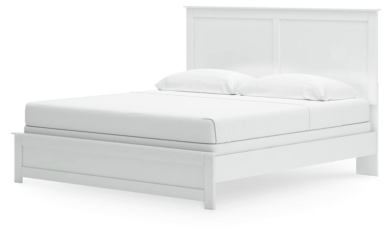 Ashley Furniture Bostwick Shoals bed with a wooden frame and headboard, shown from an angled perspective in a bedroom setting.