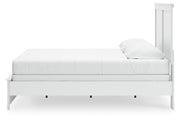 Ashley Furniture Bostwick Shoals bed with a dark wood finish and classic design, shown from a side angle.