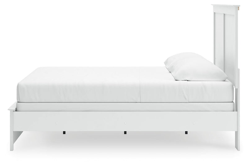Ashley Furniture Bostwick Shoals bed with a dark wood finish and classic design, shown from a side angle.