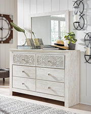 Ashley Furniture Paxberry youth bedroom set with a bed, nightstand, and dresser in a modern, stylish bedroom scene.