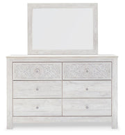 Ashley Furniture Paxberry youth bedroom set with a headboard, dresser, and nightstand in a modern bedroom setup.