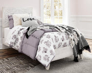 Ashley Furniture Paxberry youth bedroom set featuring a bed with a headboard and matching furniture in a cozy bedroom setting.