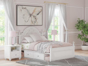 Ashley Furniture Kozlani upholstered bed with a plush fabric headboard and sleek frame, shown in a modern bedroom setting.