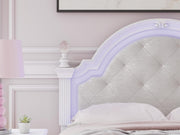 Purple upholstered Ashley Furniture bed with detailed headboard and plush fabric, styled for a modern bedroom.