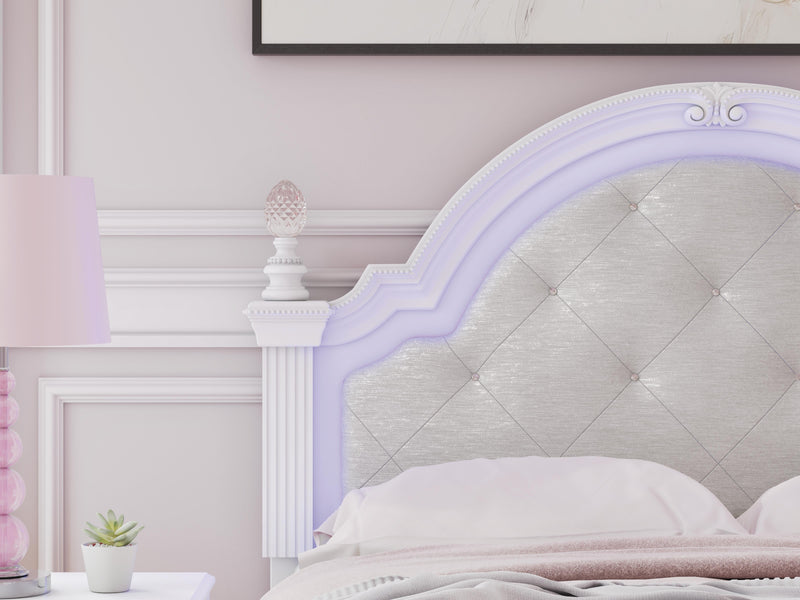 Purple upholstered Ashley Furniture bed with detailed headboard and plush fabric, styled for a modern bedroom.