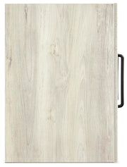 Ashley Furniture Cambeck narrow chest of drawers with a sleek top and multiple drawers in a modern bedroom setting.