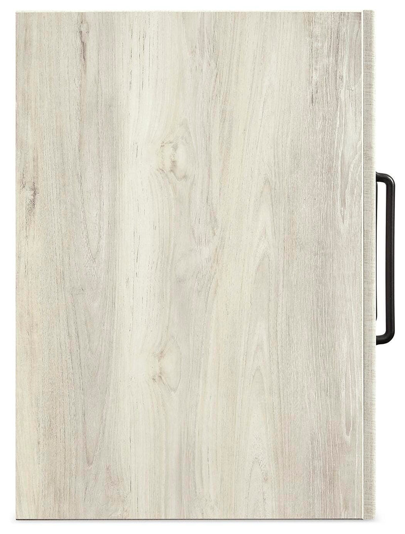 Ashley Furniture Cambeck narrow chest of drawers with a sleek top and multiple drawers in a modern bedroom setting.