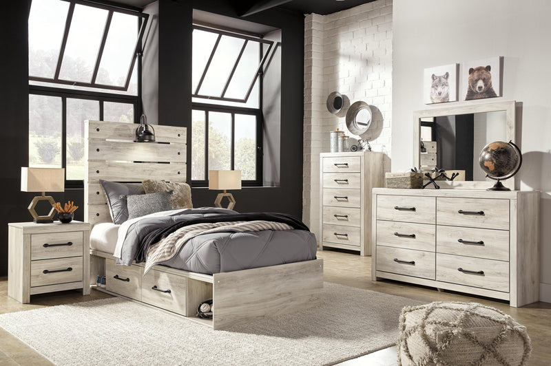 Ashley Furniture Cambeck bed with four storage drawers, sturdy wood frame, and classic design for bedroom organization.