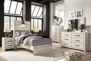 Ashley Furniture Cambeck Bed showcasing a modern wooden bed frame with a sleek headboard and natural wood finish.