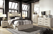 Ashley Furniture Cambeck Bed with 4 storage drawers, shown in a modern bedroom setting, featuring a dark wood finish and sleek design.