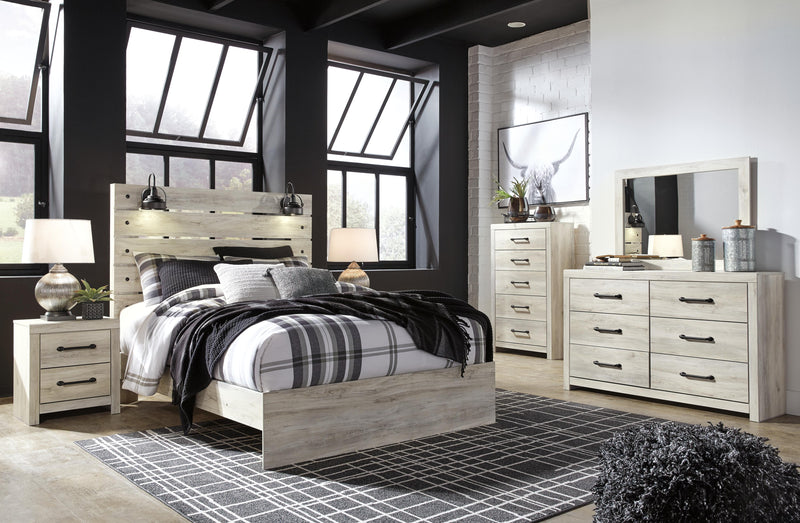 Ashley Furniture Cambeck Bed with a sturdy wooden frame and detailed headboard design, shown in a stylish bedroom setting.