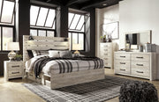 Ashley Furniture Cambeck bed with four storage drawers in a modern wooden design, shown with a neutral-toned room setting