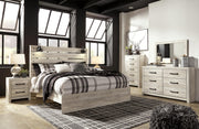 Ashley Furniture Cambeck Bed with a sturdy wooden frame and classic design, shown in a cozy bedroom setting.