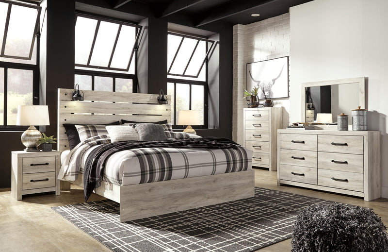 Ashley Furniture Cambeck Bed with a sturdy wooden frame and classic design, shown in a cozy bedroom setting.
