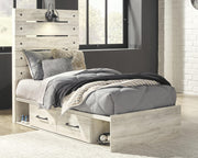 Ashley Furniture Cambeck bed with four storage drawers in a modern bedroom setting featuring a wooden frame and sleek design.