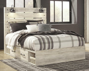 Ashley Furniture Cambeck bed with two storage drawers, showcasing a stylish wooden bed frame with built-in storage in a modern bedroom setting.
