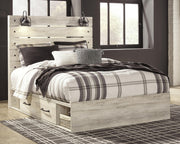 Ashley Furniture Cambeck bed with four storage drawers, showcasing a sturdy wooden frame and spacious storage in a modern bedroom setting.