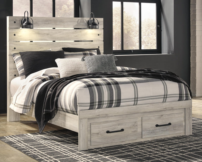 Ashley Furniture Cambeck Bed with two storage drawers, wooden frame, and clean design, shown in a bedroom setting.