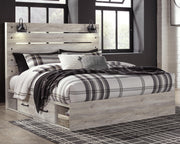 Ashley Furniture Cambeck bed with four storage drawers, featuring a modern wooden frame and built-in under-bed storage.