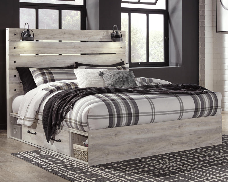 Ashley Furniture Cambeck bed with four storage drawers, featuring a modern wooden frame and built-in under-bed storage.