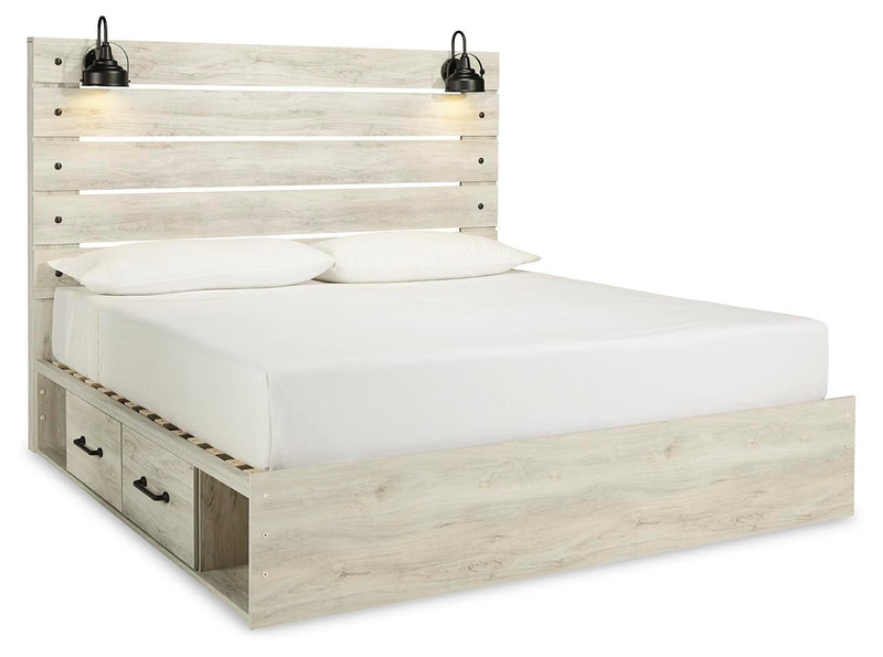 Ashley Furniture Cambeck bed with four storage drawers, featuring a sturdy frame and elegant design in a bedroom setting.