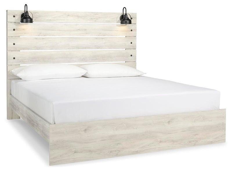 Ashley Furniture Cambeck Bed with a stylish wood frame and angled headboard, shown from a side angle in a well-lit bedroom scene.