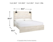 Ashley Furniture Cambeck bed with a wooden frame and upholstered headboard, shown in a cozy bedroom setting.