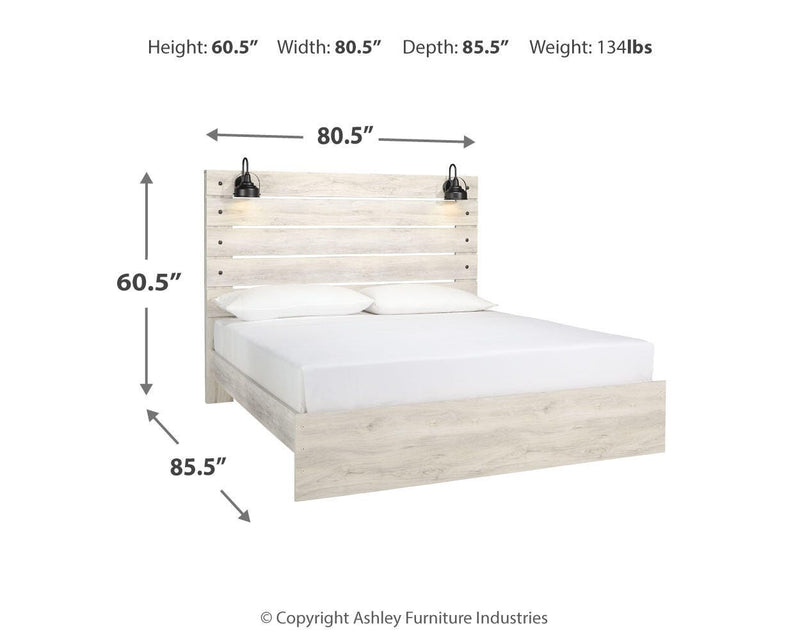 Ashley Furniture Cambeck bed with a wooden frame and upholstered headboard, shown in a cozy bedroom setting.