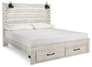 Ashley Furniture Cambeck bed with two storage drawers, shown from an angled side view highlighting the bed frame and drawers.